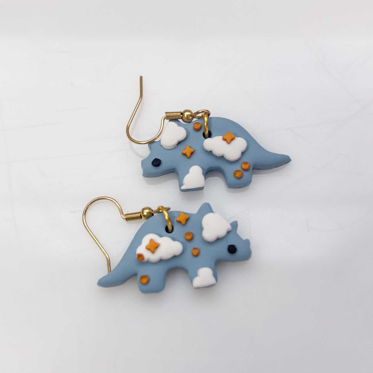 CLOUDY DINO EARRINGS (TRICERATOPS)