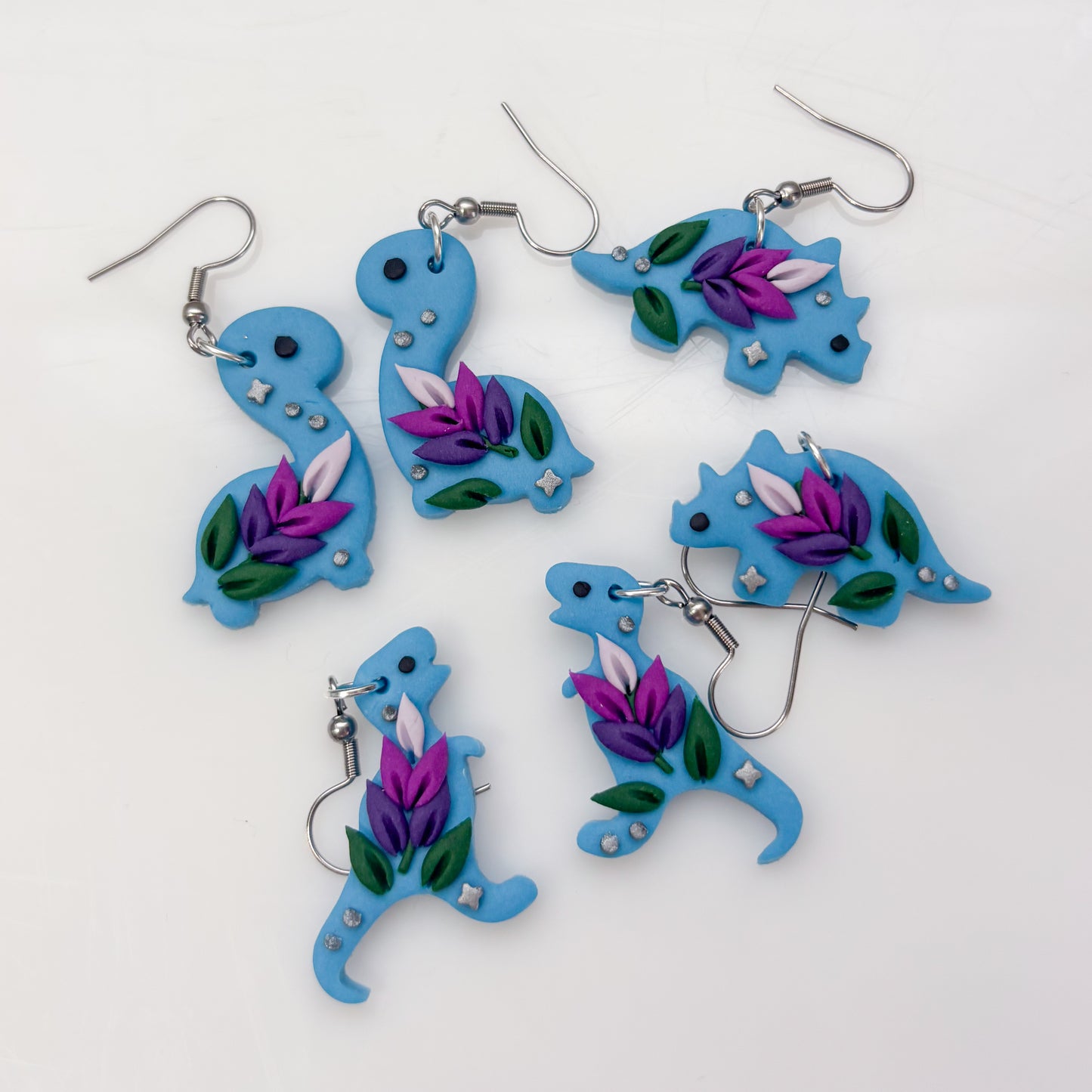 BLUE LAVENDER DINO EARRINGS (TRICERATOPS)