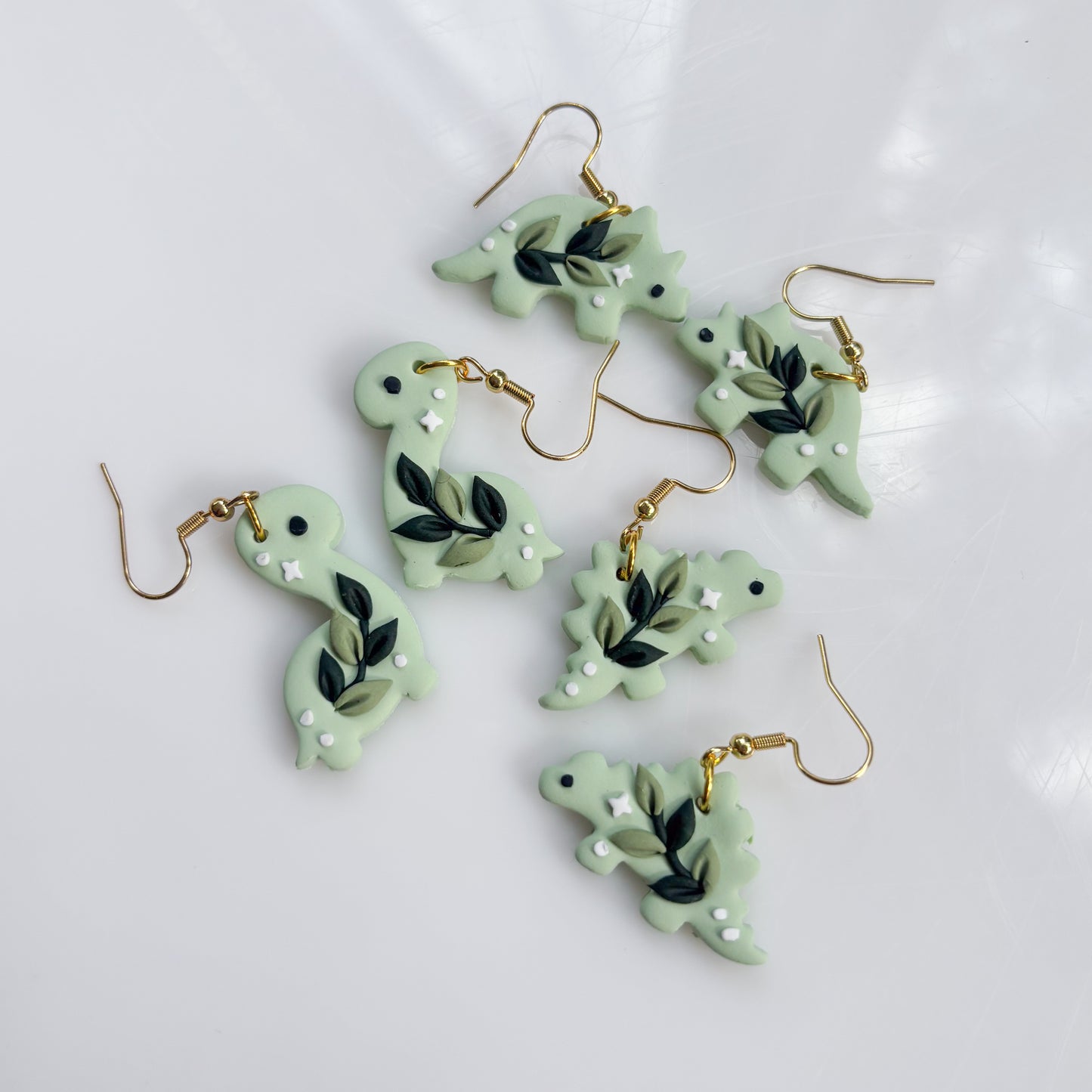 GREEN VINE DINO EARRINGS (TRICERATOPS)