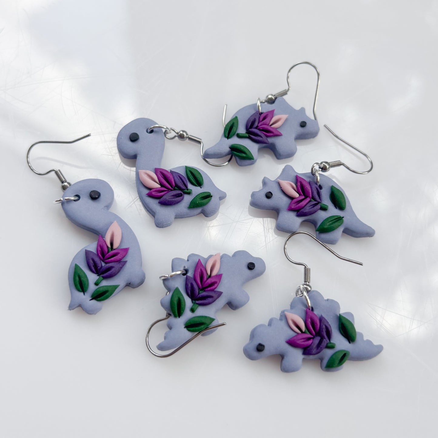 LAVENDER DINO EARRINGS (STEGO)