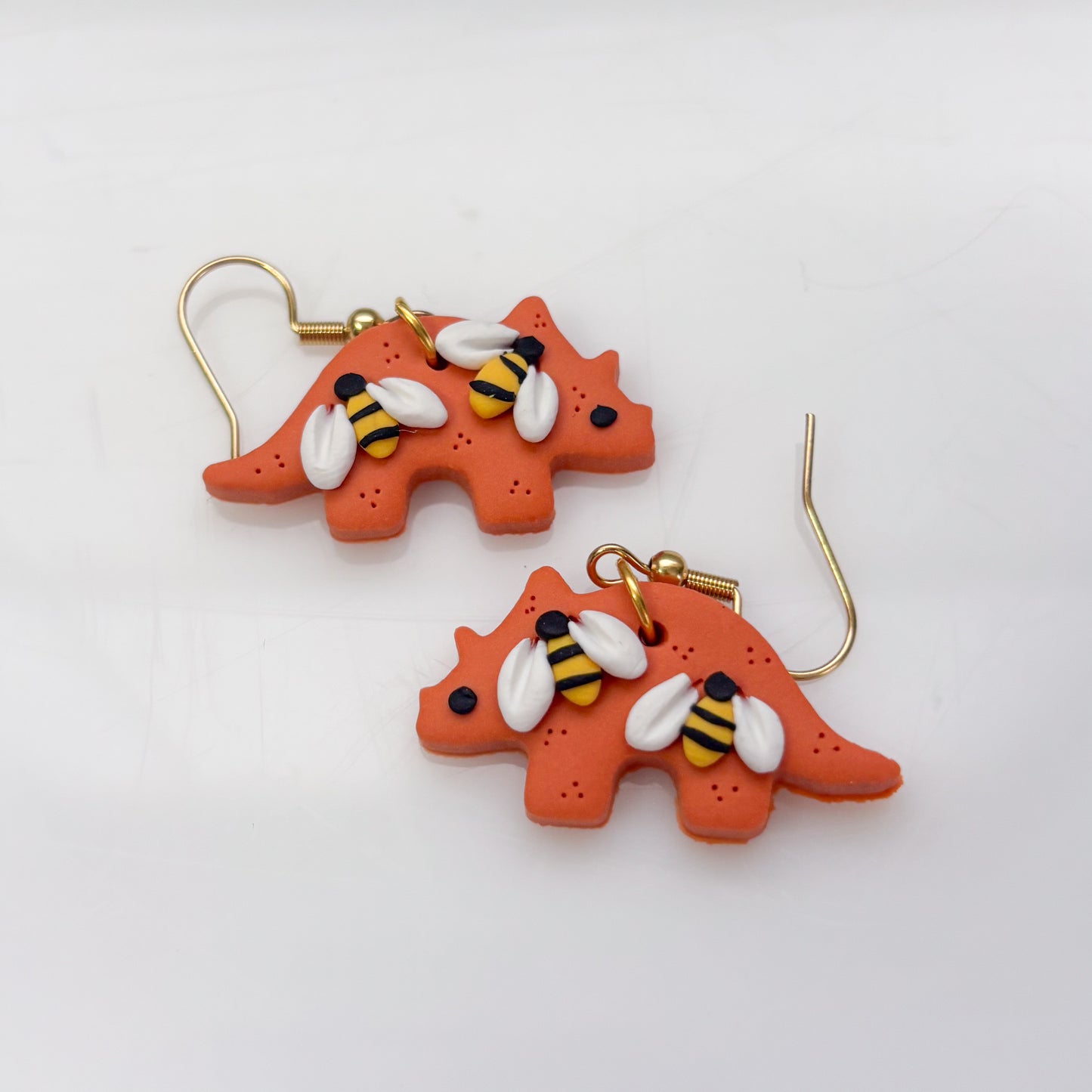 ORANGE BEE DINO EARRINGS (TRICERATOPS)