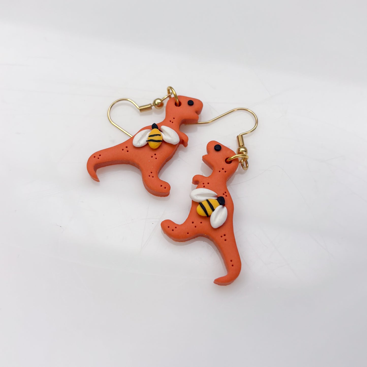 ORANGE BEE DINO EARRINGS (T REX)