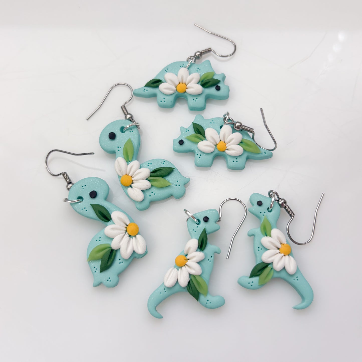 AQUA DAISY DINO EARRINGS (TRICERATOPS)