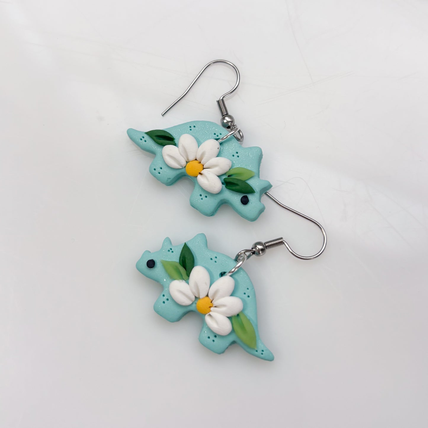 AQUA DAISY DINO EARRINGS (TRICERATOPS)