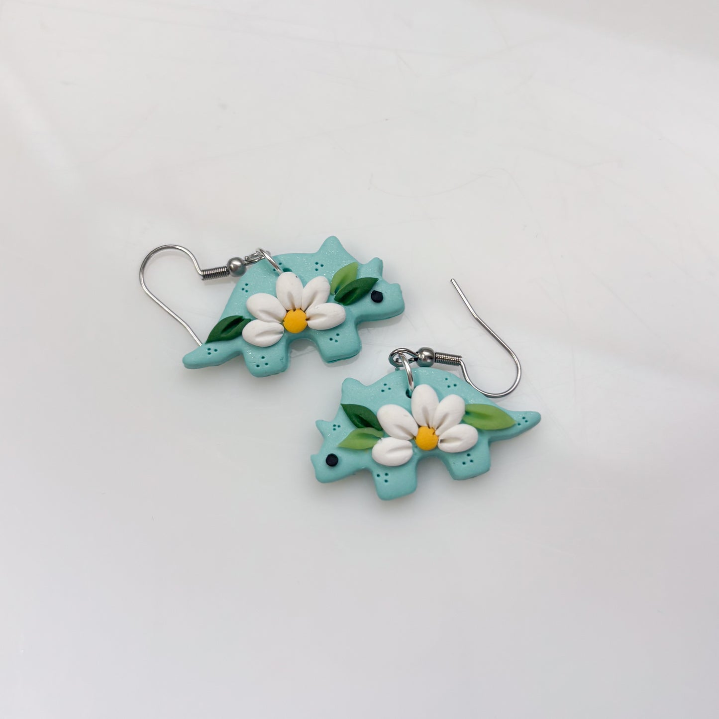 AQUA DAISY DINO EARRINGS (TRICERATOPS)