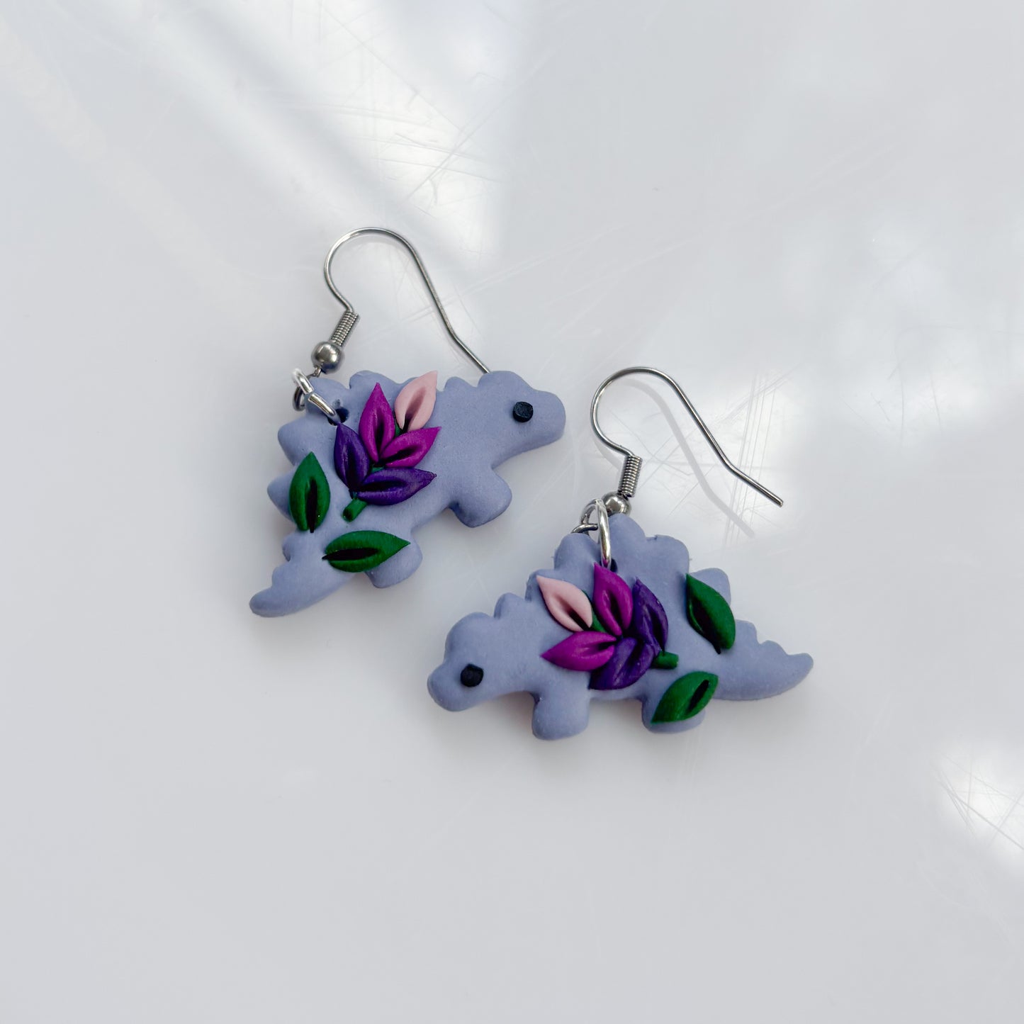 LAVENDER DINO EARRINGS (STEGO)