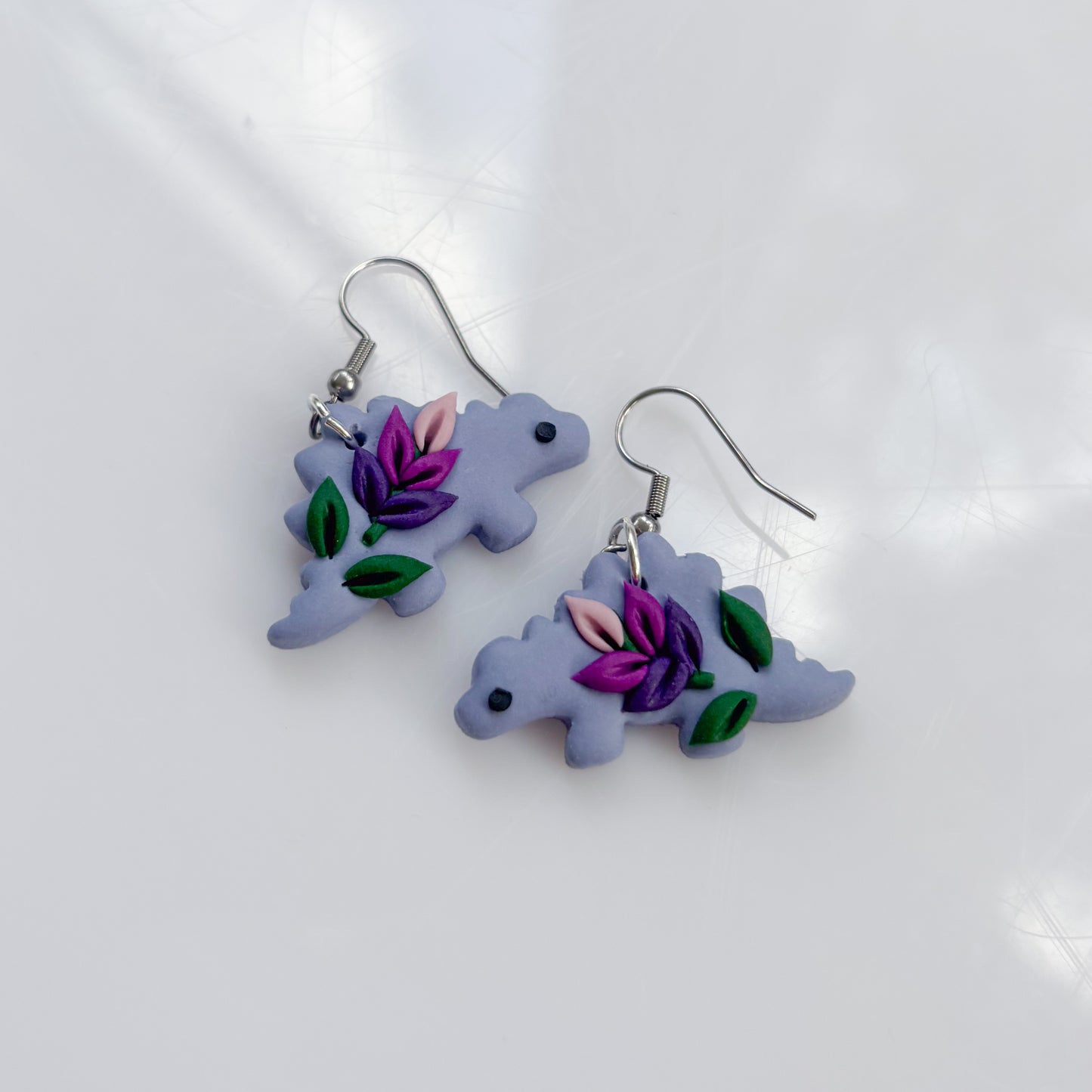 LAVENDER DINO EARRINGS (STEGO)