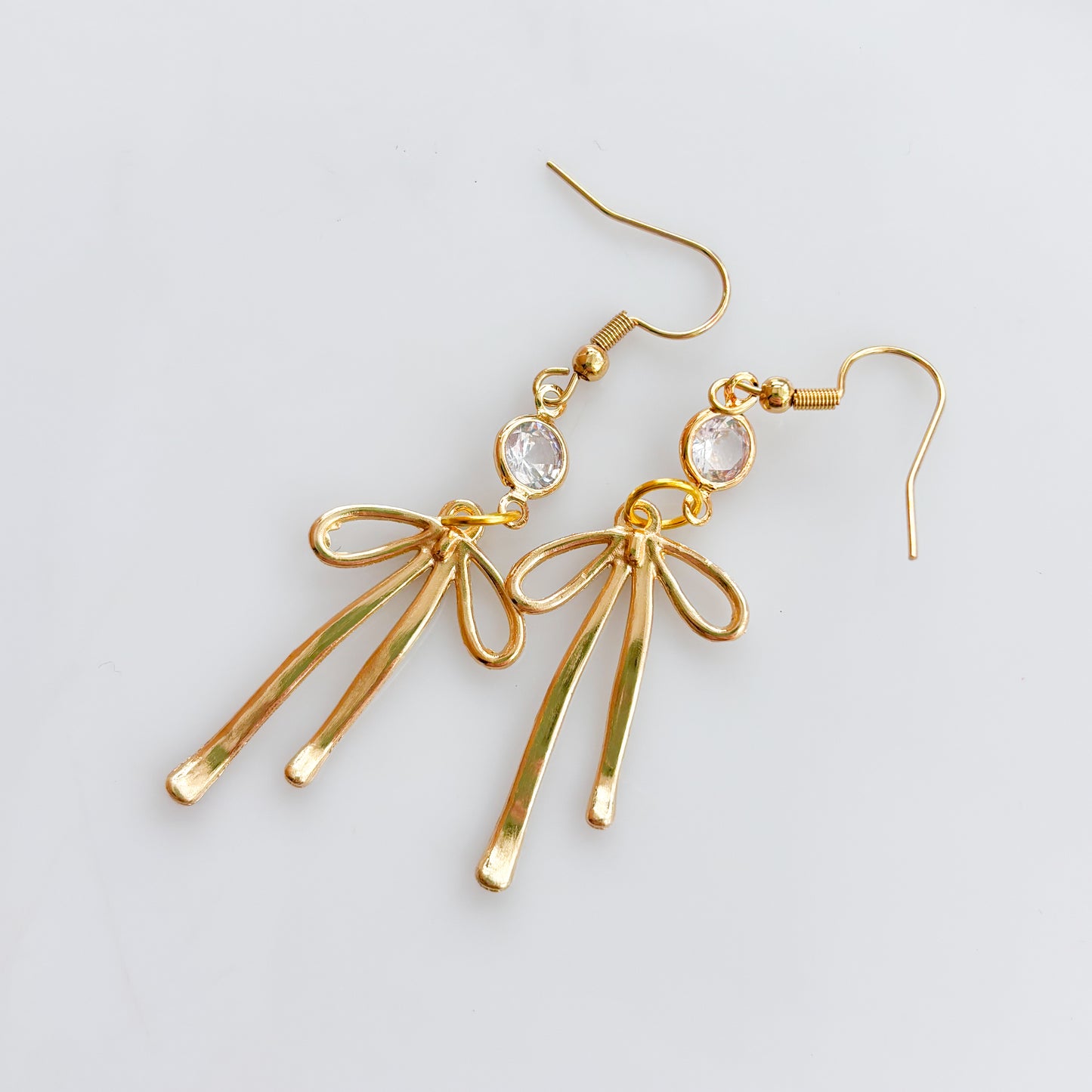 LONG GOLD BOW & GEM CHARM EARRINGS