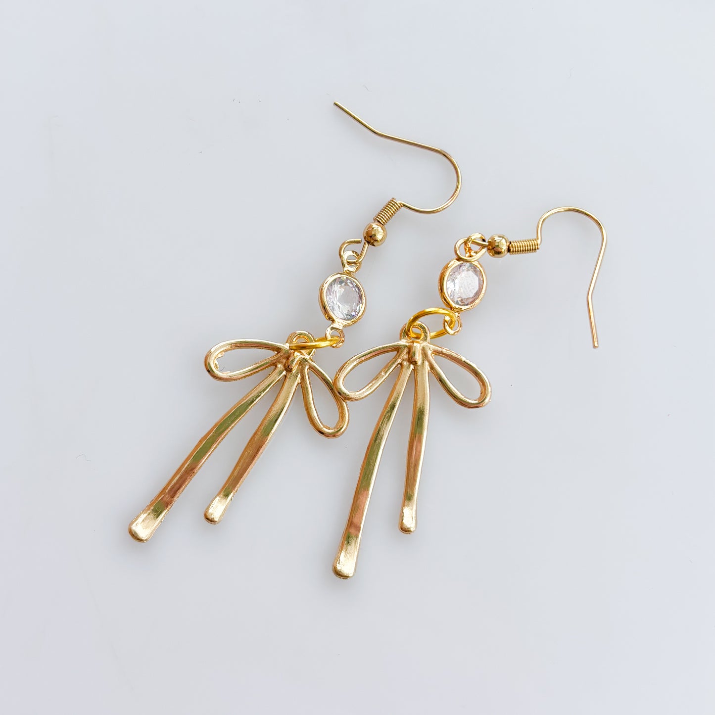 LONG GOLD BOW & GEM CHARM EARRINGS