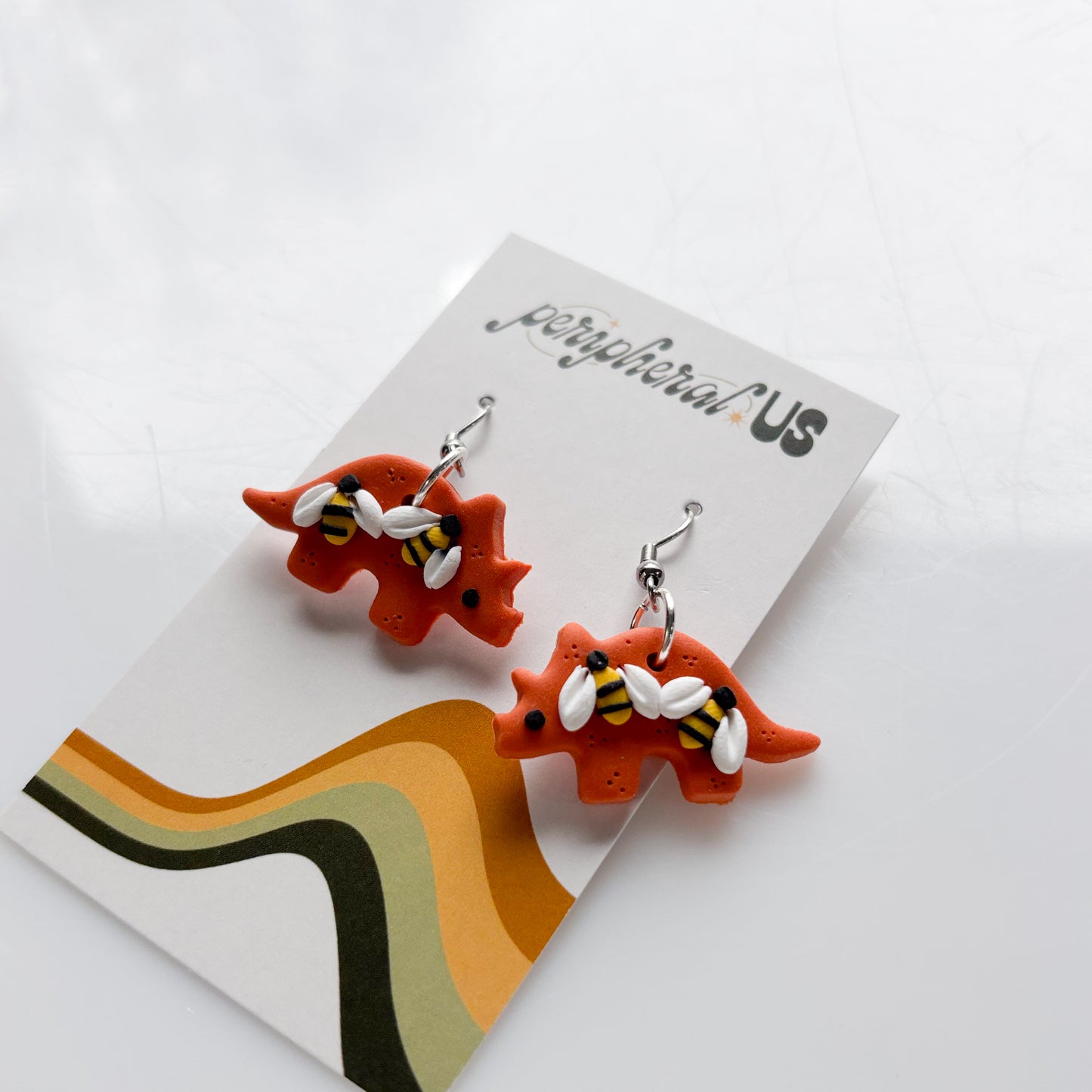 ORANGE BEE TRICERATOPS EARRINGS