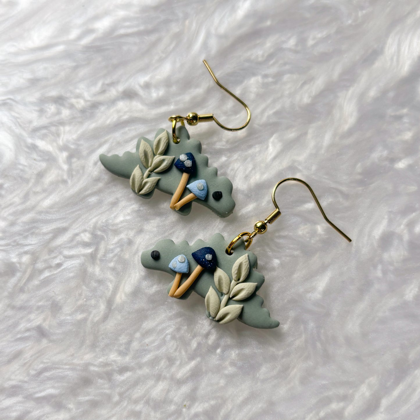 BLUE MUSHROOM DINO EARRINGS (STEGOSAURUS)