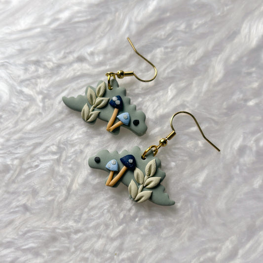 BLUE MUSHROOM DINO EARRINGS (STEGOSAURUS)