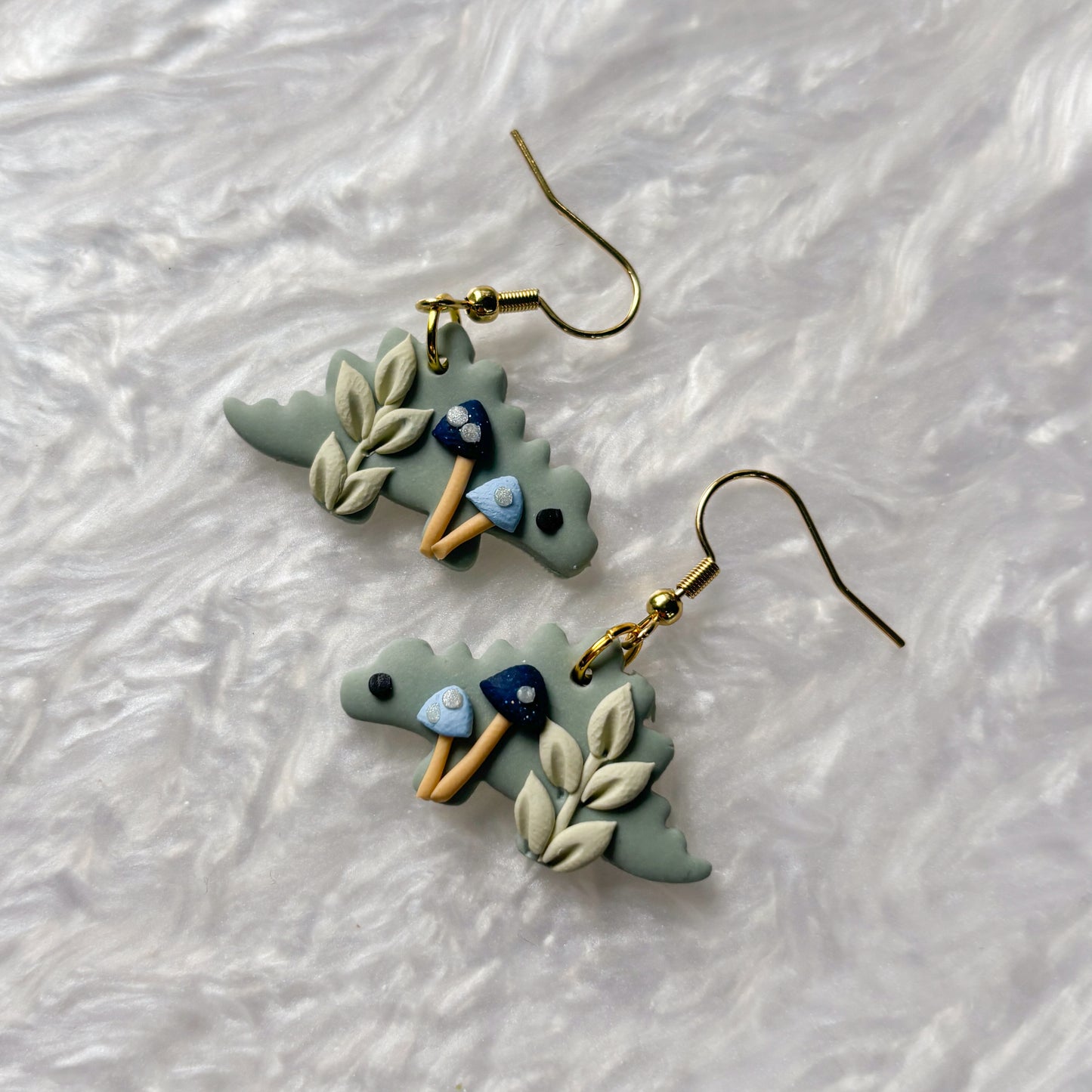 BLUE MUSHROOM DINO EARRINGS (STEGOSAURUS)